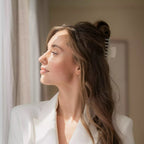 Side view of a woman wearing the beige pearlescent claw clip